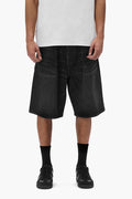 P059 Pleated Short in black, baggy fit with pleats, button fly, and front slash pockets.