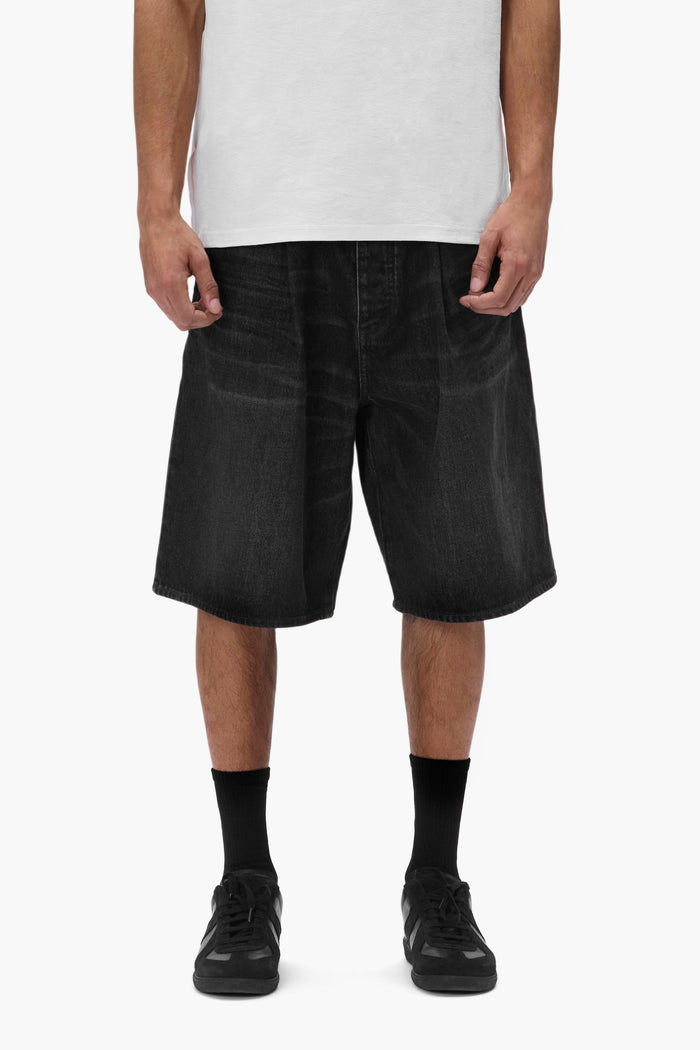 P059 Pleated Short in black, baggy fit with pleats, button fly, and front slash pockets.