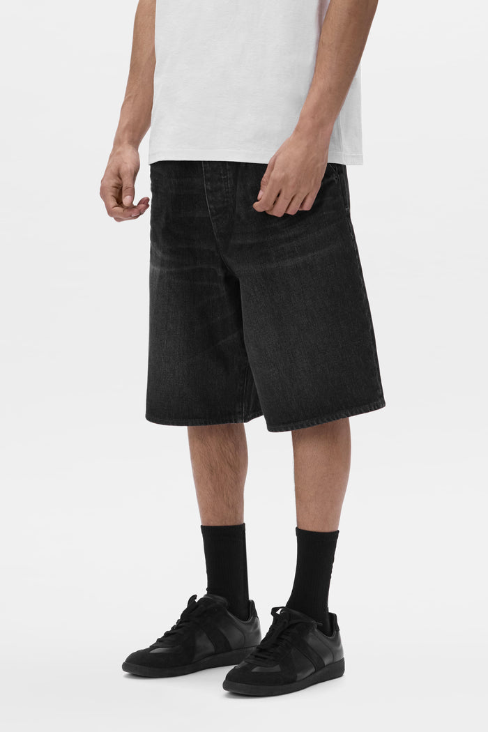 P059 Pleated Short with baggy fit, featuring button fly and front slash pockets.