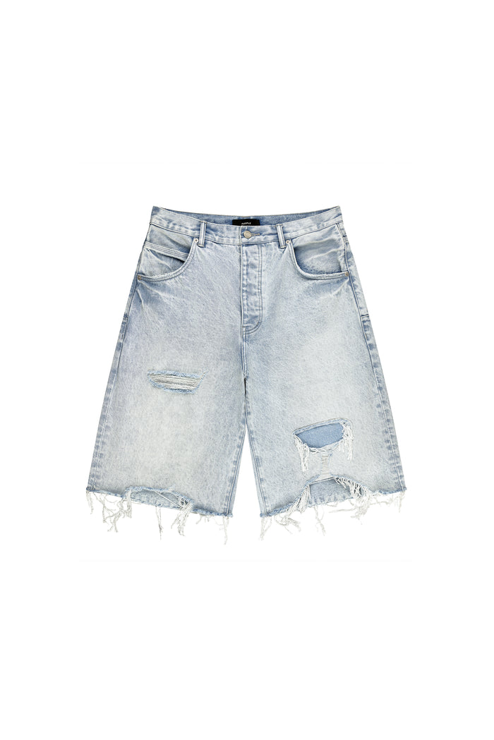 P070 Blowout Patched Short in Light Indigo with raw cut hem and wide leg design.