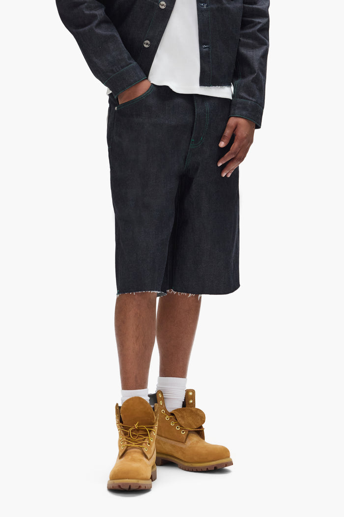 P070 Raw Shorts in Clean Dark Indigo with wide leg and raw cut hem, available in sizes 28-40.
