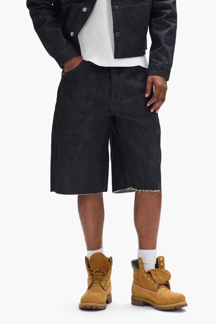 P070 Raw Shorts in Clean Dark Indigo with wide leg and raw cut hem, available in various sizes.