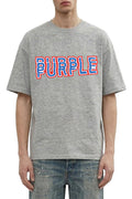 Purple Wordmark Tee with raised emb wordmark, made of 100% cotton, available in various sizes.
