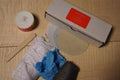 The TY Fine Furniture Solid Wood Furniture Touch-Up & Repair Kit includes a box, jar, cotton cloth, blue gloves, wooden stick, circular filter, and steel wool—ideal for scratch repair or oil and wax finishes.