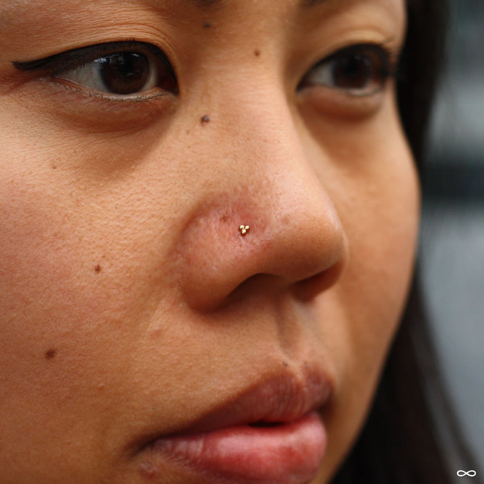 Nostril piercing with Tri Bead Cluster Press-fit End in Gold from BVLA in 14k Yellow Gold