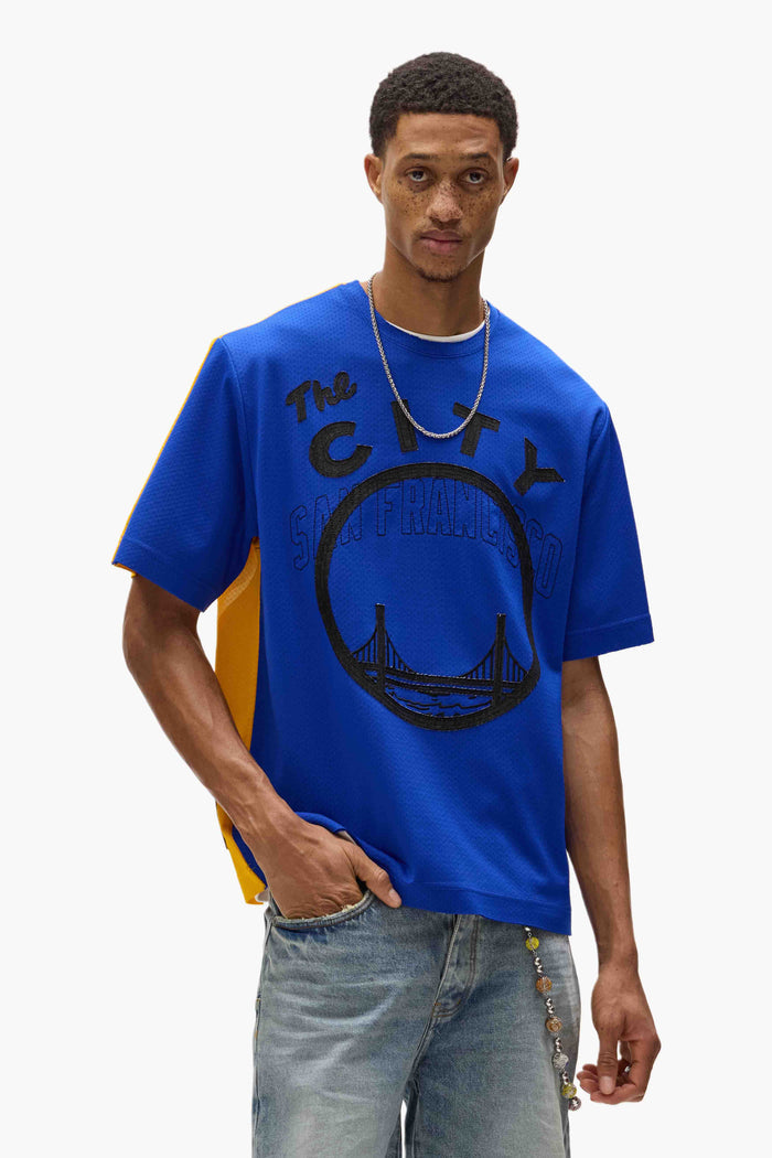 Warriors Mesh Tee oversized fit with embroidered graphics and contrast color details.