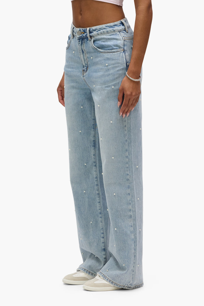 Wide Pearl Hotfix high-rise denim with relaxed leg and hotfix pearls, available in sizes 24-34.